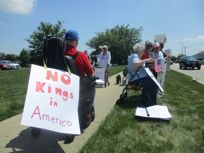 Senior citizen protestors line a stretch of River Road outside the Timbers of Shorewood senior living center. Junw 14, 2025