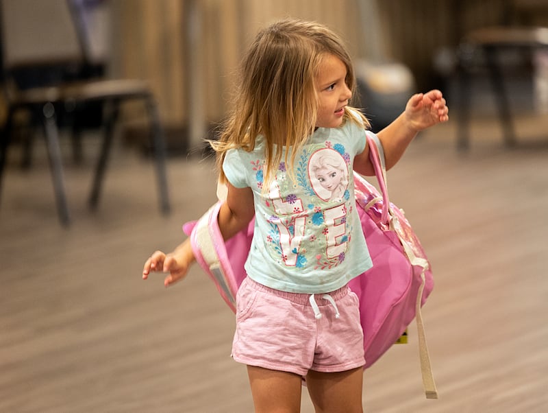 Sarah Callaway, 4, tries on her new backpack Thursday, Aug. 8, 2024, at the Tools for Schools distribution in Dixon.