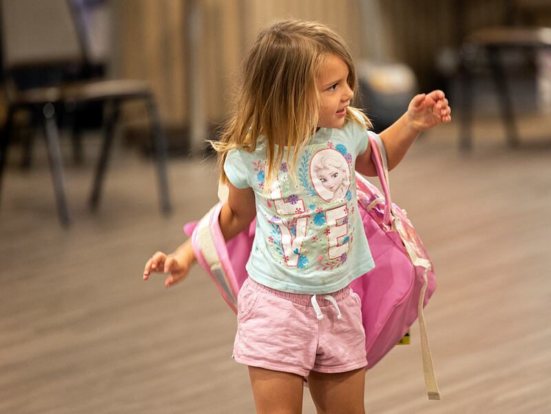 Sarah Callaway, 4, tries on her new backpack Thursday, Aug. 8, 2024, at the Tools for Schools distribution in Dixon.