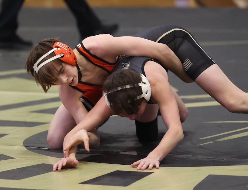 DeKalb’s Matthew Frykman controls Sycamore’s Chase Cook during their 106 pound match Friday, Jan. 16, 2026, at Sycamore High School.