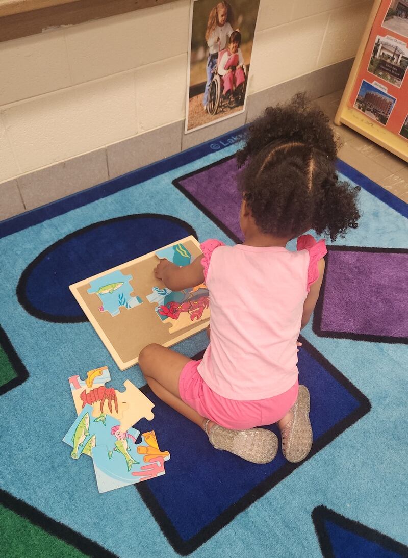A child in the Catholic Charities of the Diocese of Joliet program is seen in 2025 working a puzzle.