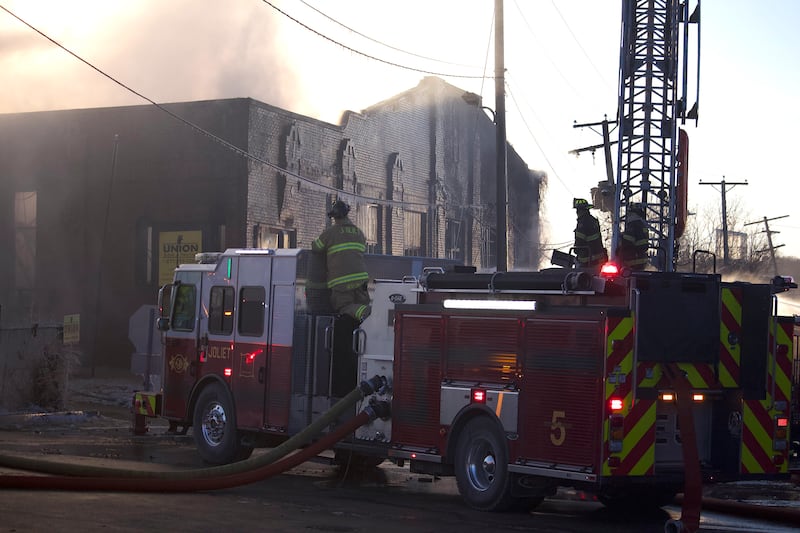 Joliet firefighters at the scene of a fire at an old commercial building on Thursday, Jan. 29, 2026, at the corner of South Eastern Avenue and Washington Street in Joliet.