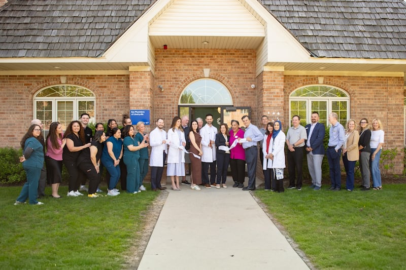 Dr. Hercules Logothetis cuts the ribbon to celebrate the opening of the second Libertyville location. Guests of honor included Mayor Donna Johnson and the GMLV Chamber of Commerce.
