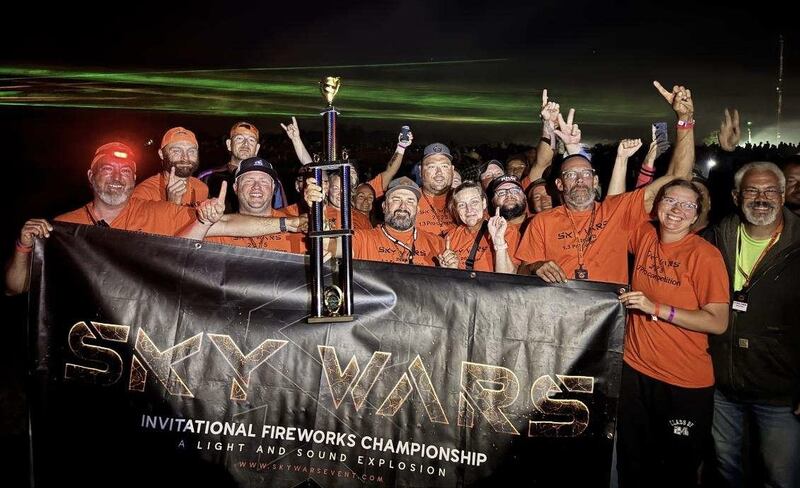 John Mikrut of Princeton, center holding the trophy, is pictured with his team after winning the Pro Division of the Star Wars premier national fireworks competition in Innsbruck, Mo.