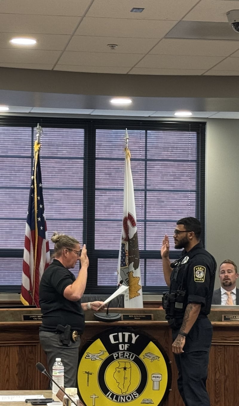 Peru Police Chief Sarah Raymond swears in Patrol Officer Manny Winfert during a Monday, May 19, 2025 council meeting.