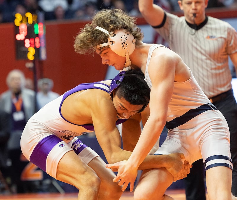 IC Catholic’s Max Cumbee (right) and Rochelle’s Xavier Villalobos compete in the 126 pound weight class of the 2A state individual wrestling finals Saturday, Feb. 22, 2025, at State Farm Center in Champaign.