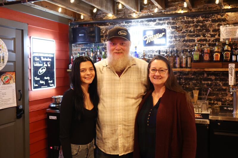 The Hideout Lounge owner, Larry Tapp, center, stands with staff members Kelsey Miller, left, and Lisa Fortin in the newest addition to The Majestic in downtown Kankakee.