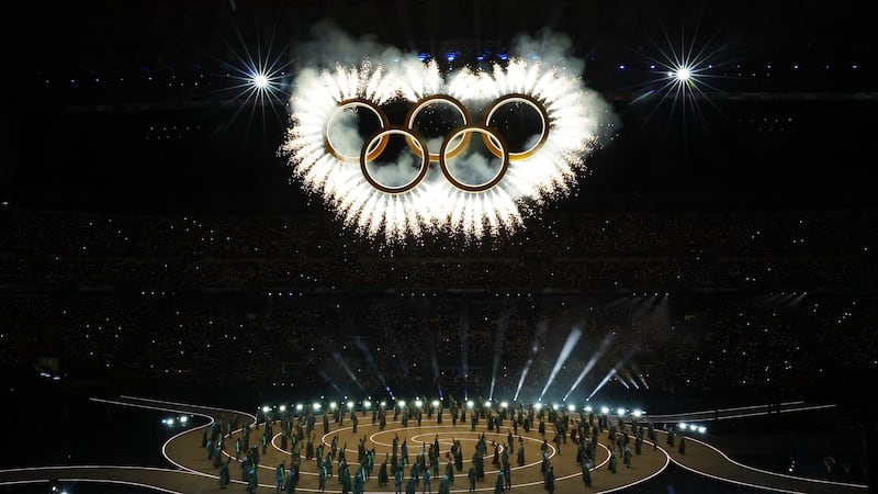 Olympians march in Milan and the mountains at a multi-site opening ceremony for the Winter Games