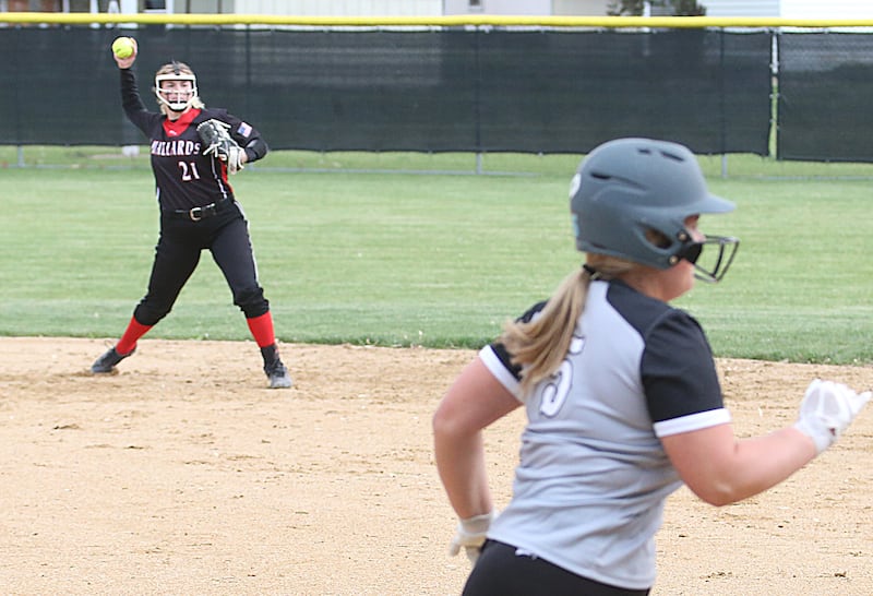 Henry-Senachwine shortstop Brooklynn Thompson (21) makes the turn on a double-play attempt as WFC batter-runner Clara Downey (5) races down the first-base line Monday, May 8, 2023, in Henry.