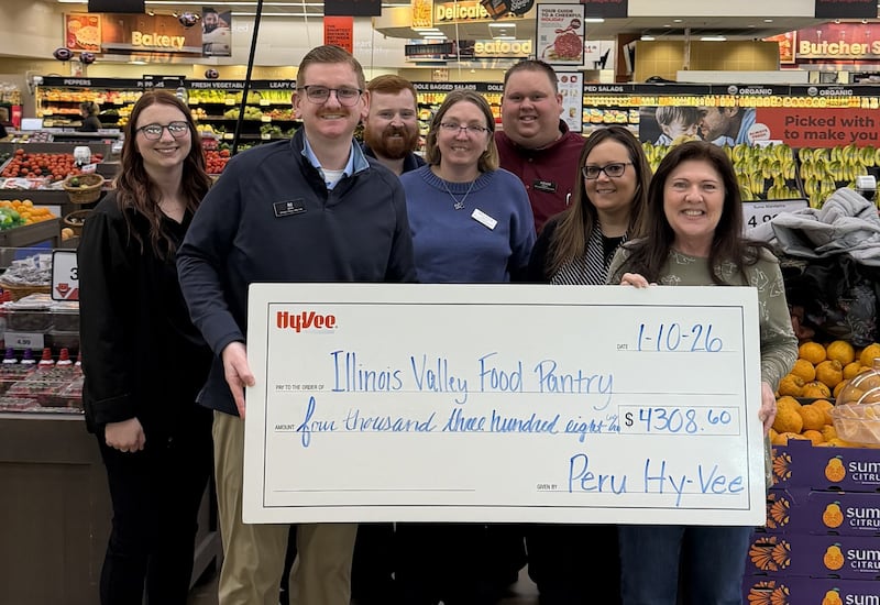 Peru Hy-Vee district store director BJ Rissi presents check to the Illinois Valley Food Pantry. The Peru Hy-Vee raised a total of $4,308.60 from the round-up campaign and the pantries each received $2,154.30 to support their hunger-fighting efforts