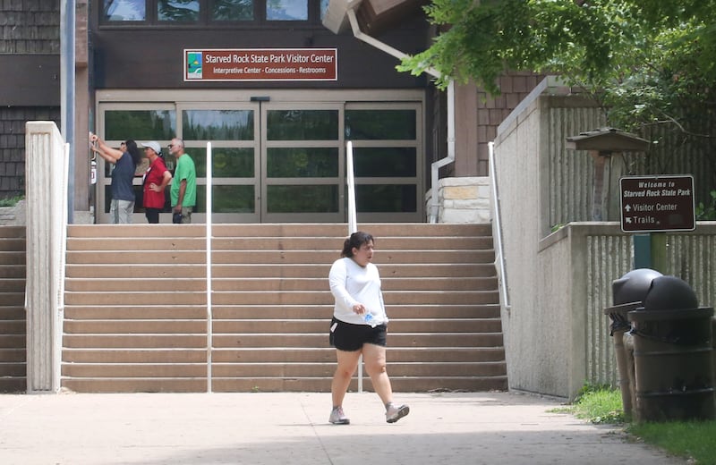 Visitors read maps outside the Starved Rock State Park Visitors Center on Thursday, July 24, 2025 at Starved Rock State Park.