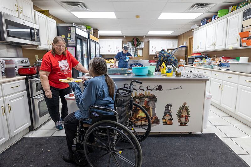 Barb Brady dishes up a meal Wednesday, Jan. 7, at the Twin Cities Homeless Shelter in Sterling. Barb and husband Mike volunteer to cook at the shelter two times a month. When they started 12 years ago there was only one person utilizing the shelter; on Wednesday there were nearly 20 clients.