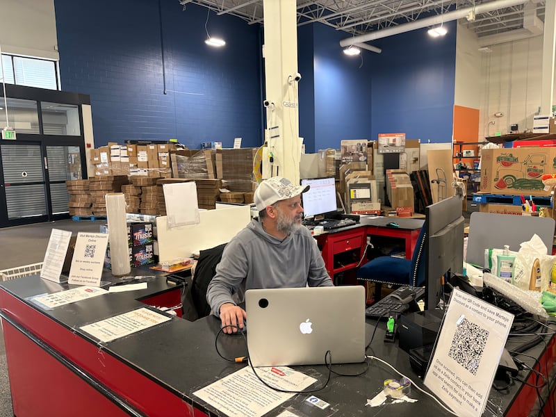 Martejo Discount owner Joedy Martell works on inventory for upcoming online auctions through his store on April 27, 2026.