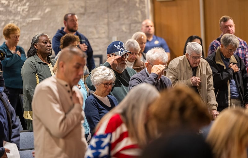 Attendees recognize Taps during a Veterans Day service Monday, Nov. 11, 2024, at Centennial Auditorium in Sterling.