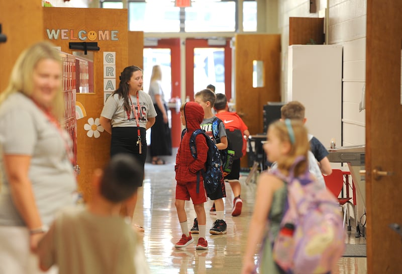 Second-grade teacher Shannon Kidd helps students get to their room on the first day of classes at Yorkville Grade School on Friday, Aug. 15, 2024.