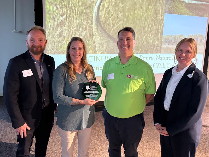 Pictured from left are Forest Preserve District of Will County Deputy Director Adam Oestmann; Forest Preserve District restoration ecologist Barbara Sherwood; Jason Zylka, ecologist with the U.S. Army Corps of Engineers, Chicago District; and Laurie Ryan, co-chair for the Excellence in Ecological Restoration Program and plant ecologist for McHenry County Conservation District.