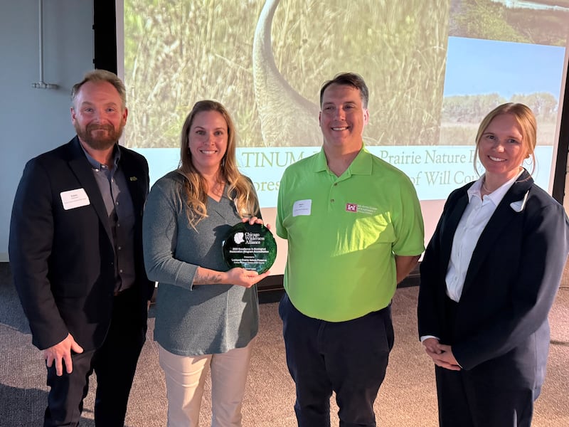 Pictured from left are Forest Preserve District of Will County Deputy Director Adam Oestmann; Forest Preserve District restoration ecologist Barbara Sherwood; Jason Zylka, ecologist with the U.S. Army Corps of Engineers, Chicago District; and Laurie Ryan, co-chair for the Excellence in Ecological Restoration Program and plant ecologist for McHenry County Conservation District.