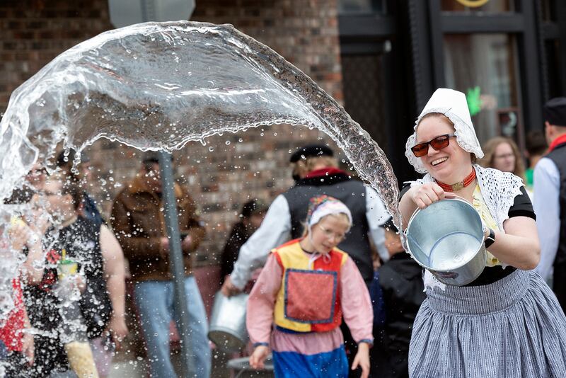 A stream of water arches through the air as the parade route is scrubbed ahead of Fulton’s Dutch Days parade Saturday, May 3, 2025.