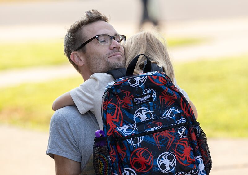 Jacob Reitzel hugs his first grade son Vann Wednesday, Aug. 14, 2024 as the youngster heads into Washington school in Dixon.