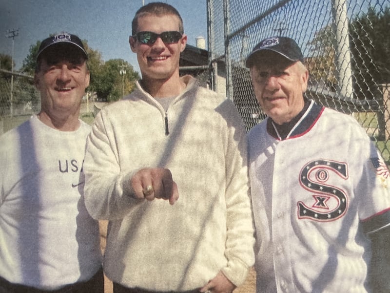 Guy Christensen, left, and Joe Schmitz, right, with Shoeless Joe Jackson's great nephew, who is holding a 1917 Chicago White Sox World Series ring.