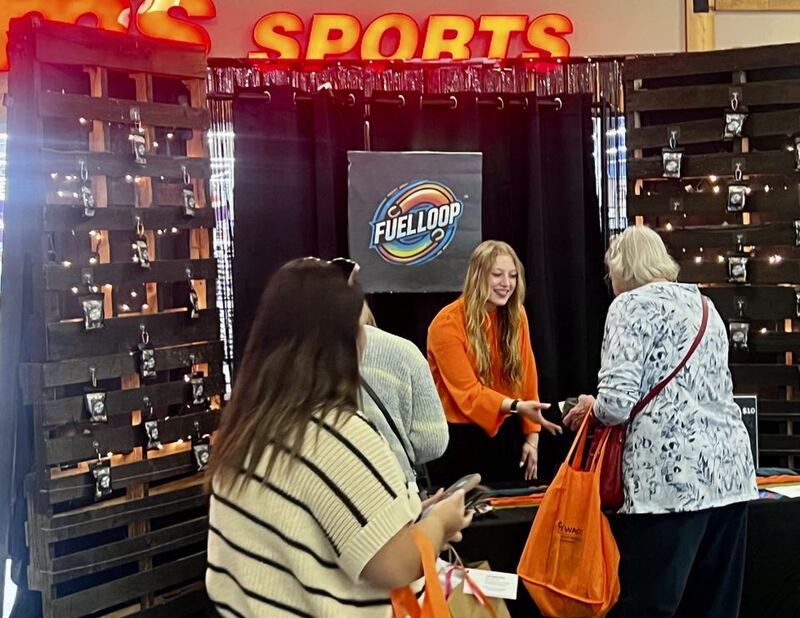 Milledgeville High School junior Natalie Pilgrim greets customers at her business, Fuel Loop, in Sterling's Northland Mall at the Whiteside Area Career Center's CEO program student trade show on April 23, 2025.