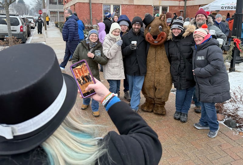 Woodstock Willie poses for photos with the crowd on Monday, Feb. 2, 2026, during the annual Groundhog Day Prognostication in the Woodstock Square.