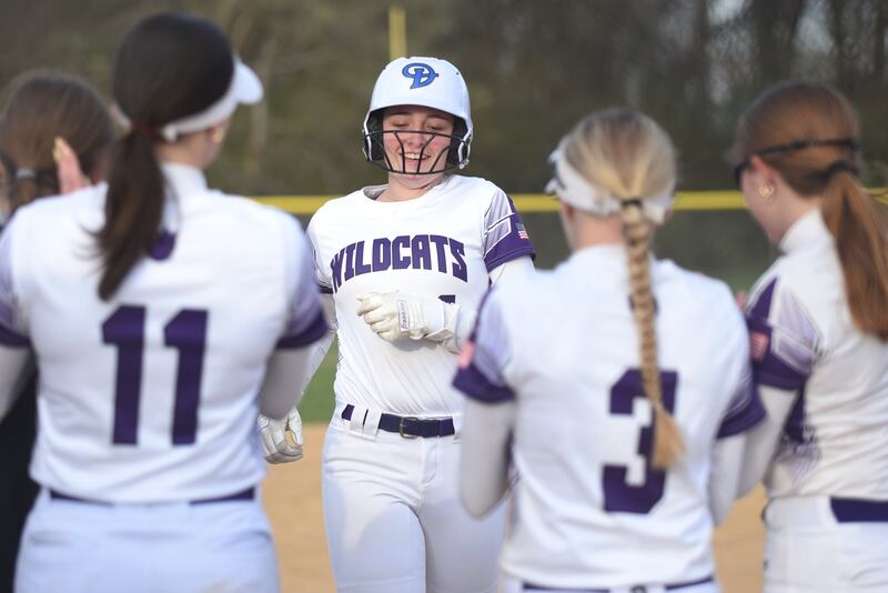 Wilmington's Ally Allgood is greeted at home plate by her teammates after hitting the Wildcats' third home run of their home game against Herscher Tuesday, April 15, 2025.