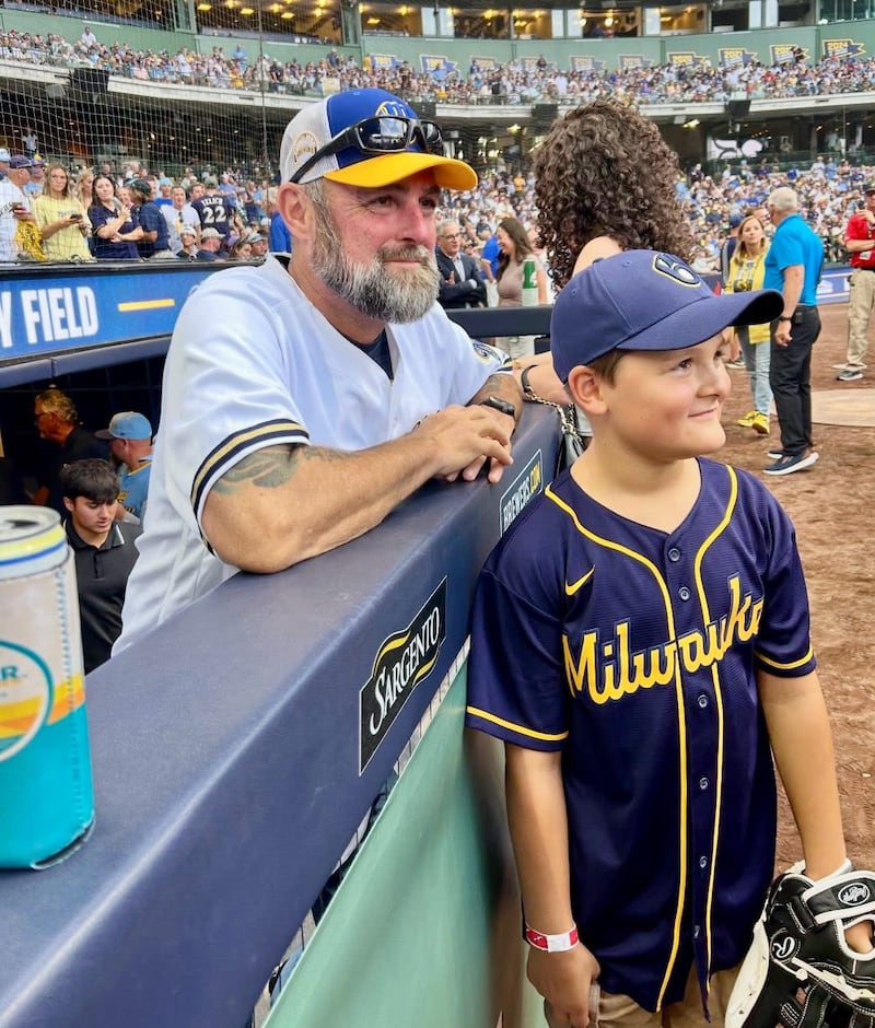 Danny Kolb and his son, Korbyn, 8, take in the 25th anniversary of the Milwaukee Brewers stadium from the Brewers dugout on Friday, July 25. Korbyn was born seven years after his dad retired from baseball and Danny said he wanted to give him a taste of the experience he lived as a player.