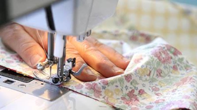 Carolyn McQuillan sews strips of fabric together while making a ruffled "Trixie" bag as a sample for her Clare quilt shop, Basketcases Unlimited. According to McQuillan, customers and workshop participants enjoy the traditional crafts of quilting and sewing and use the art to escape the rush of everyday life. KATE WEBER CARLSON | kcarlson@daily-chronicle.com