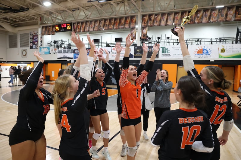 Beecher players celebrate winning the RVC Championship trophy following the Bobcats' victory in two sets, 25-22, 25-23, over Grant Park on Monday, Oct. 20, 2025, at Beecher High School.