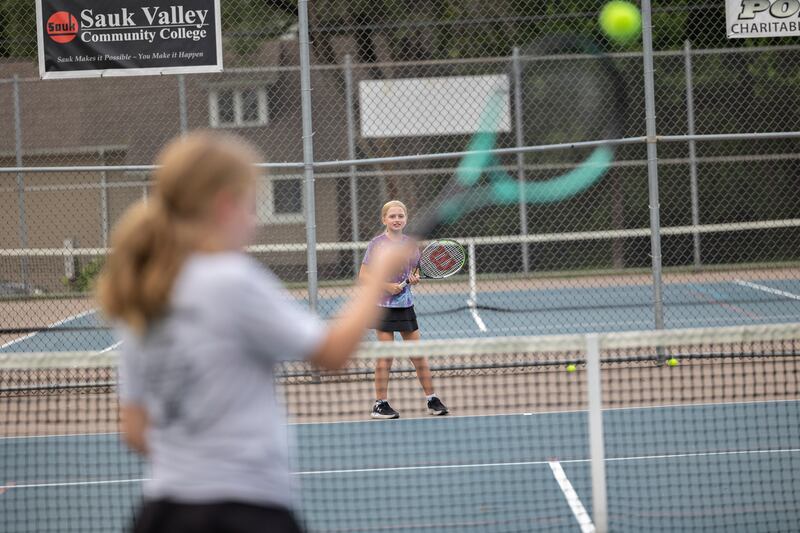Maddie Dobie, 12, waits for a serve from sister Ella, 14, on Friday, July 25, 2025, during a family fun day at the Emma Hubbs Tennis Classic.