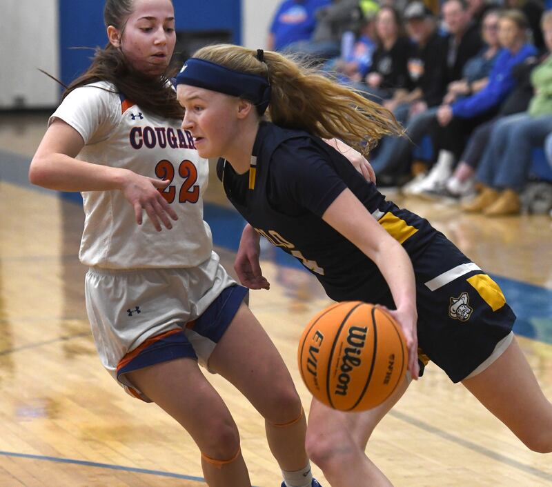 Polo's Camrynn Jones (4) drives the baseline as Eastland's Sienna Peterson (22) defends on Tuesday, Feb. 10, 2026 at Eastland High School in Lanark.