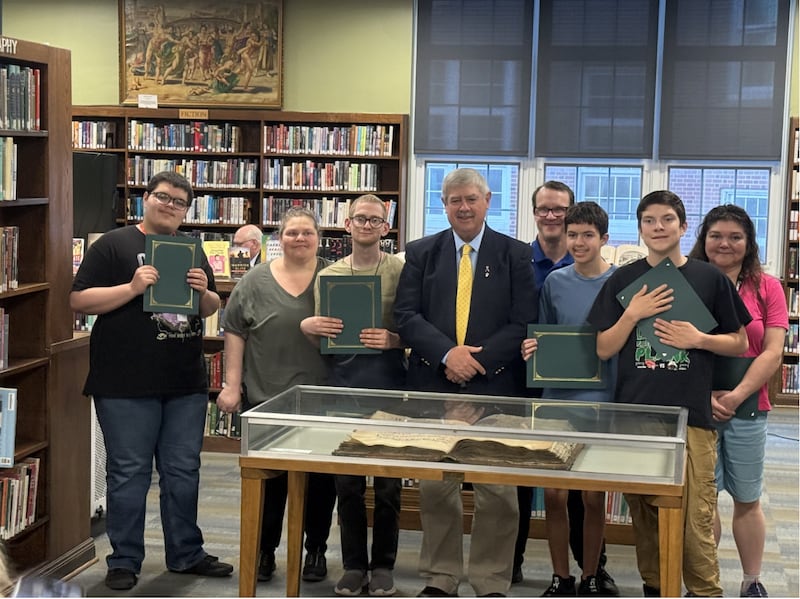 LPHS Board President Greg Sarver presents Special Olympics athletes who qualified in Winter Games events with a certificate on Wednesday, April 22.