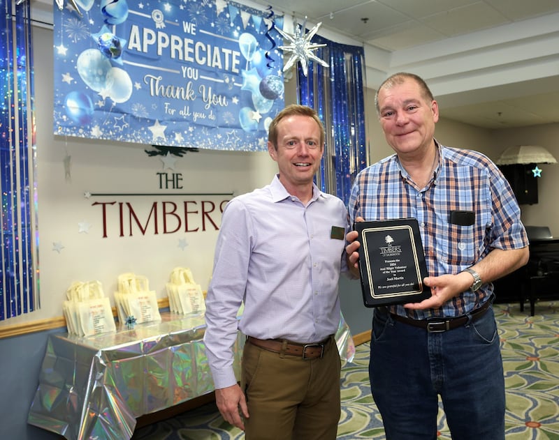 Kevin Young, executive director at The Timbers of Shorewood (left), hands Joel Martis his Volunteer of the Year award during The Timbers of Shorewood volunteer appreciation luncheon on Tuesday, April 14, 2026.