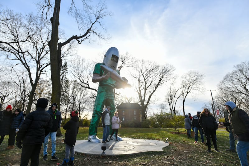Attendees linger to take photos with the Gemini Giant on Saturday during the Gemini Giant Homecoming event at Wilmington's South Island Park.