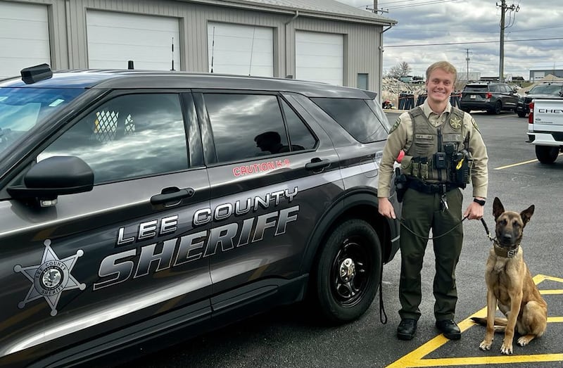 Lee County Sheriff Department's Deputy Justin Hart stands next to his new canine partner, Dax.