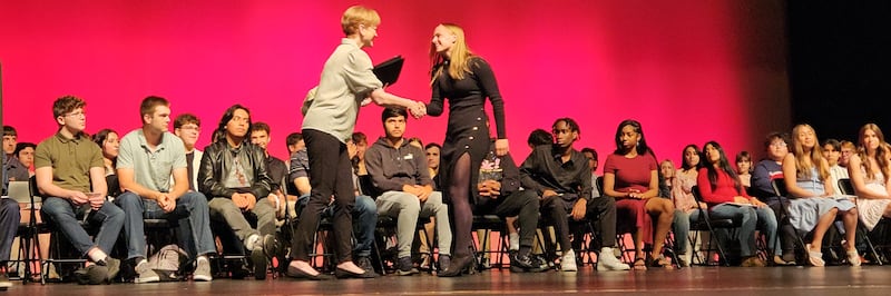 Kishwaukee Symphony Orchestra principal violinist and board member Lynn Slater presenting the KSO High School Senior Musician Scholarship to Jenna Zimmerman