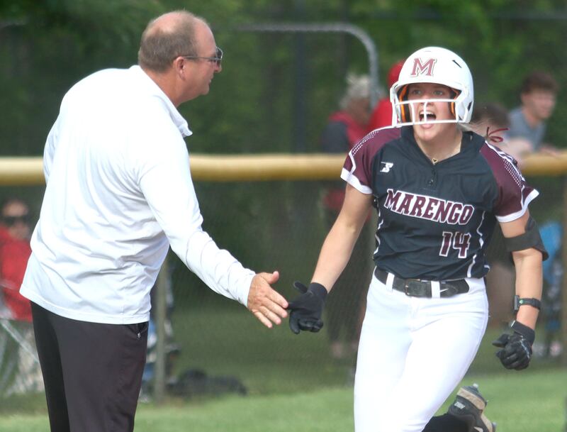 Marengo’s Kylee Jensen is greeted by Head Coach Dwain Nance after belting a solo home run against Morrison in IHSA Class 2A Sectional Semifinal softball action at Marian Central High School in Woodstock on Thursday, May 29, 2025.