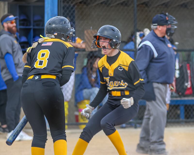 Joliet West's Ella Featherston (4) celebrates her inside the park homerun with Joliet West's Alaina Grohar (8) during softball game between Joliet West at Joliet Central on Tuesday, April 15, 2025 in Joliet.