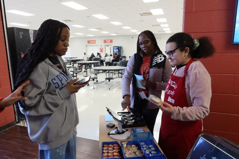 Jacqueline Salinas rings up a Brew Den Customer paying with Apple Pay.