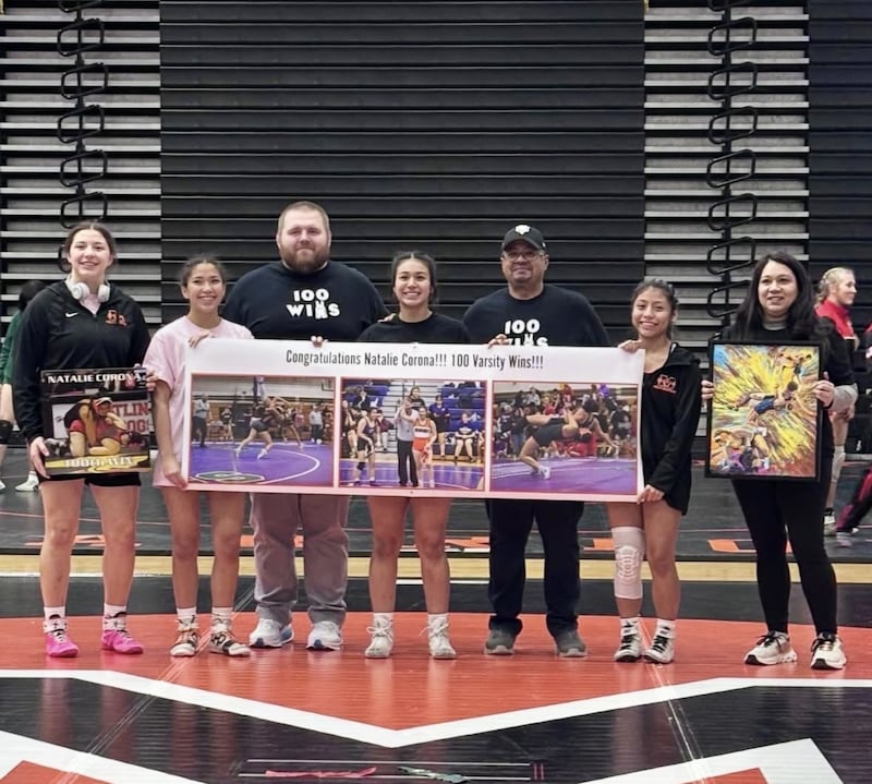 McHenry's Natalie Corona is honored after earning her 100th career win during her team's home dual tournament on Jan. 3.