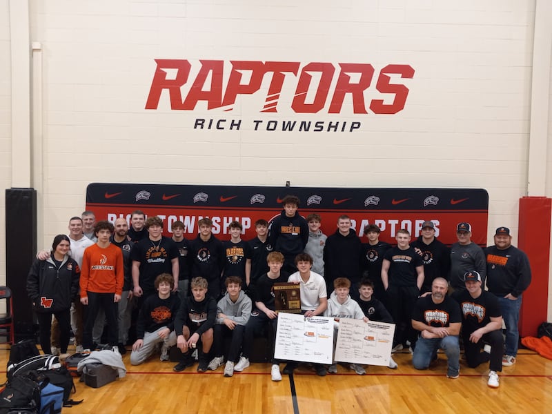The Lincoln-Way West boys wrestling team poses with their plaque after winning the IHSA Class 3A Rich Township Regional title on Jan. 31, 2026.
