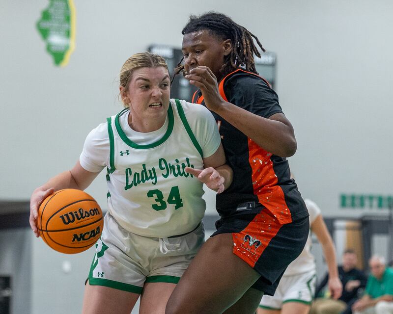 Tessa Krull (34) of Seneca pushes into Nyanna Payton (30) of Peoria Manual in championship game against Peoria Manual on Saturday, November 22, 2025 at Seneca High School in Seneca.