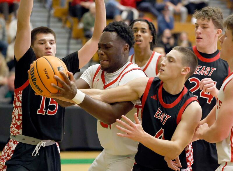 Palatine's Tony Balanganayi (50) is fouled by Glenbard East's Michael Nee (4) during the 51st Jack Tosh Holiday Classic basketball tournament Monday, Dec. 29, 2025 at York High School in Elmhurst.