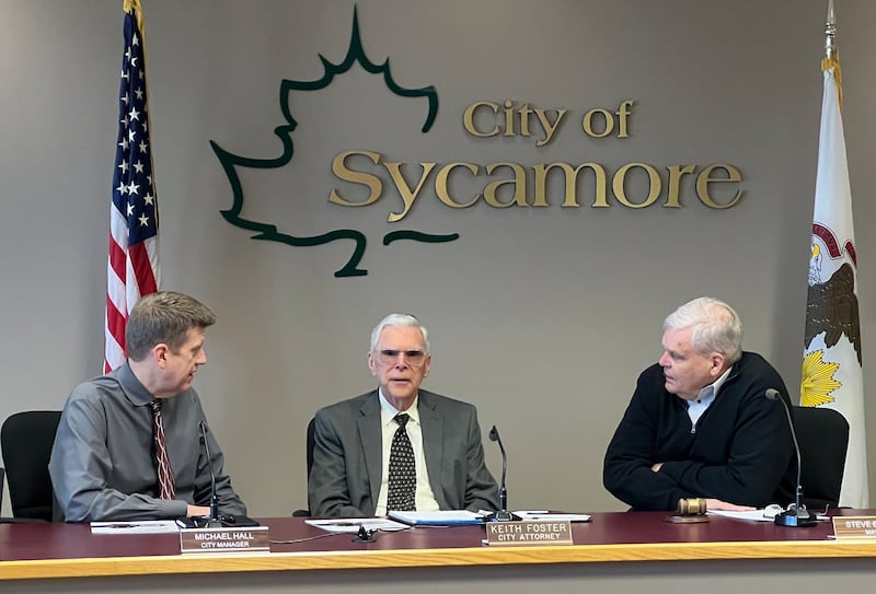Sycamore City Manager Michael Hall, City Attorney Keith Foster and Sycamore Mayor Steve Braser talk with each other ahead of a Sycamore City Council meeting on April 6, 2026.