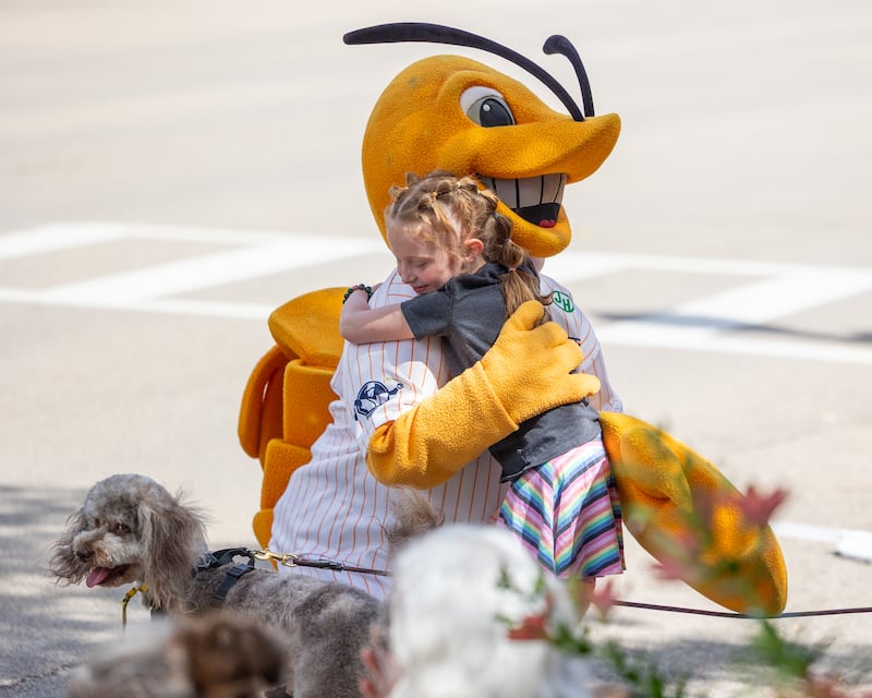 Ophelia Evans embraces 'Southclaw Sam' mascot of the Illinois Valley Pistol Shrimp during the 5th annual Ottawa Family Pride Festival parade on June 13, 2026 on Lasalle St. in Ottawa.