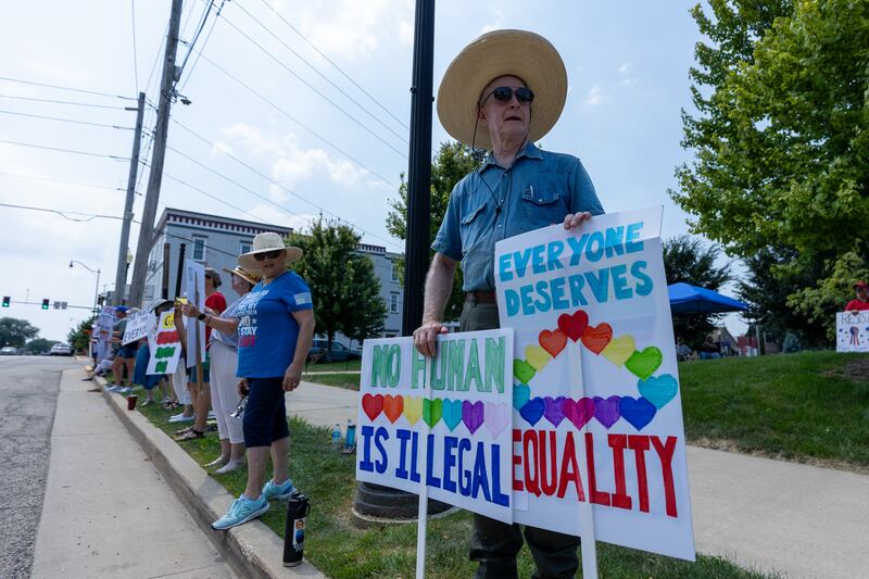 Protesters hold signs at the “No Kings” protest on Saturday,  August 9, 2025 at Rotary Park in Princeton.