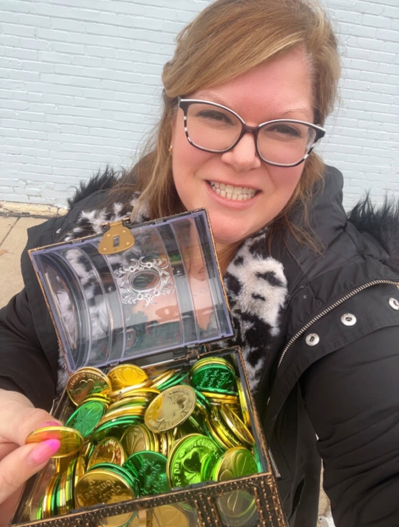 Kristen Cornelio with the gold coins for participating merchants in the Feb. 13-March 23 Lucky Charms promotion.