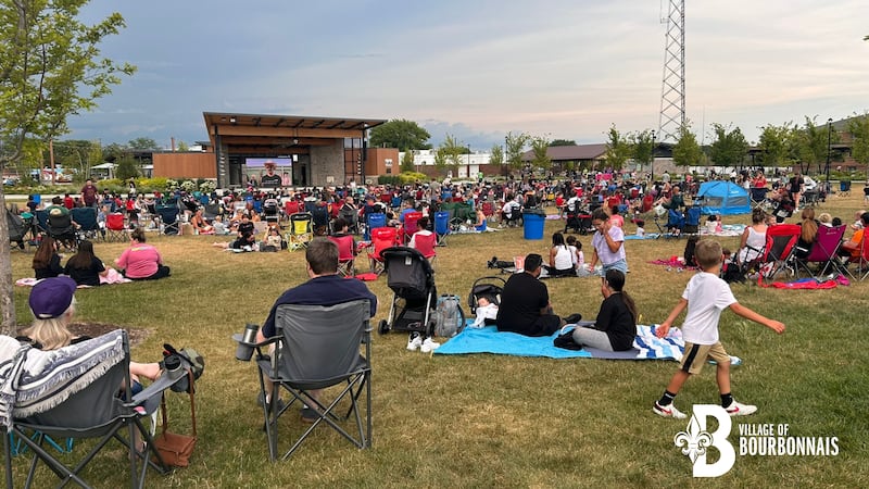 Families settle in with lawn chairs and blankets for a free outdoor movie under the stars at The Grove in Bourbonnais.