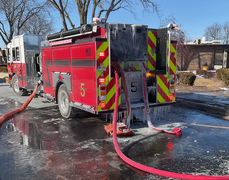 An icy Joliet Fire Department vehicle at the scene of a fire at Dirksen Junior High School on Friday, Jan. 23, 2025, in Joliet.